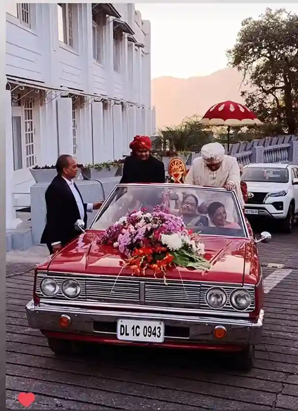 Red Classic 1960s decorated wedding car in baraat